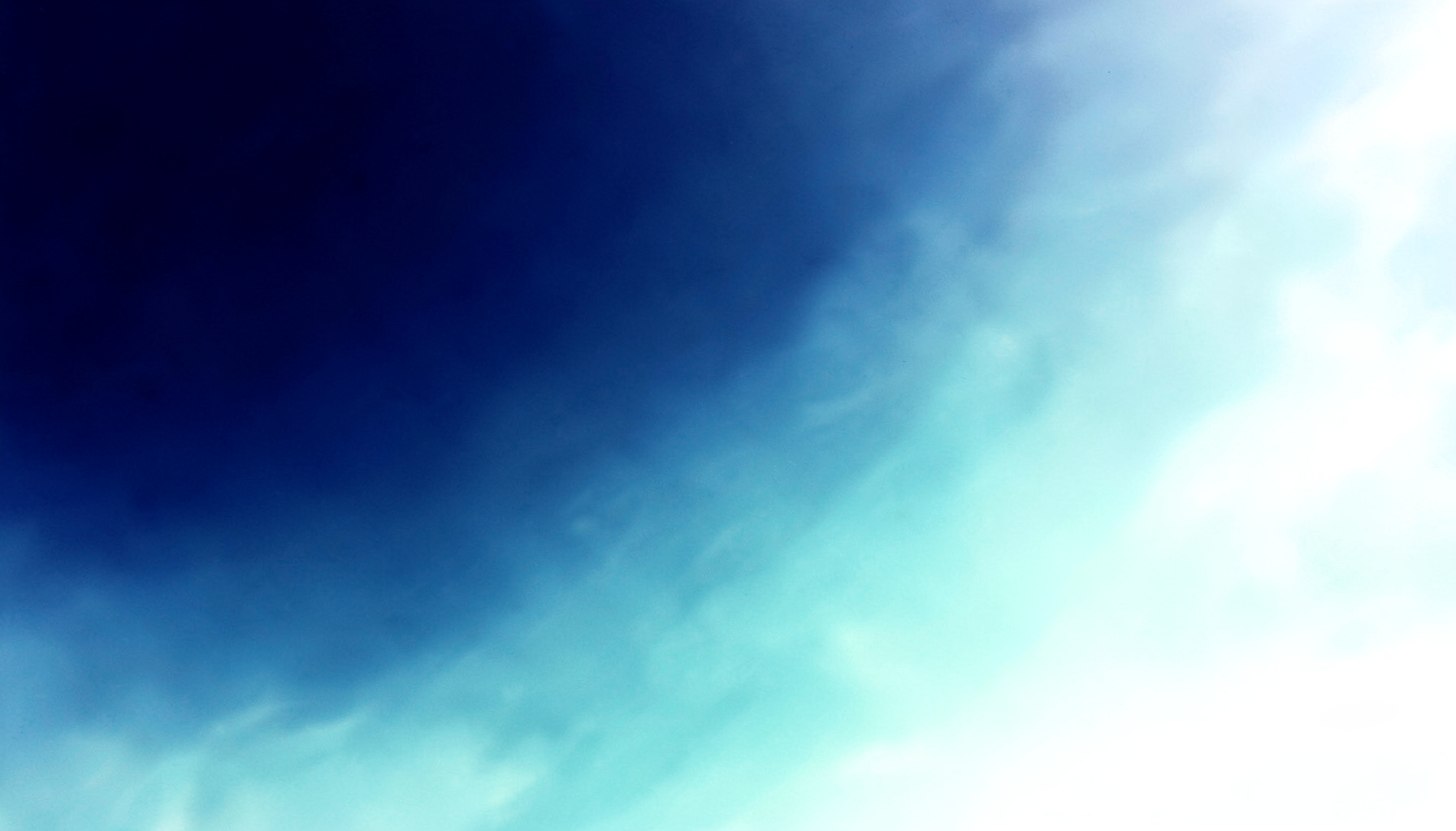 Soft abstract gradient of deep navy blue fading into lighter teal tones, with a subtle organic fluid texture suggesting water and movement